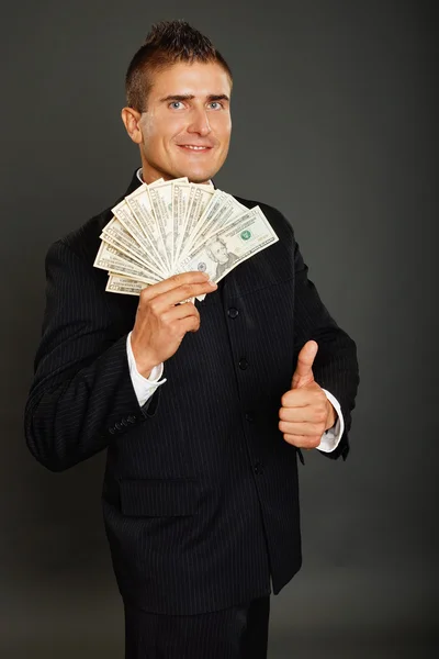 Мужчина позирует с деньгами и жестом вверх — стоковое фото
