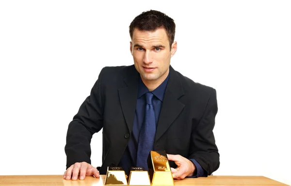 Businessman with gold bricks — Stock Photo, Image