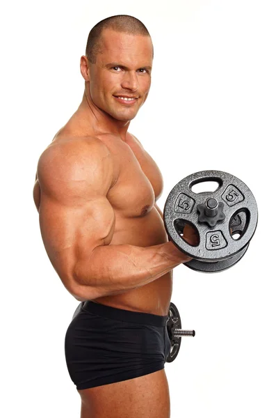 Muscular man poses with dumbbells — Stock Photo, Image