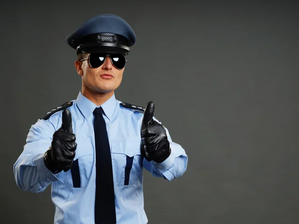 Polisman visar tummen upp tecken — Stockfoto