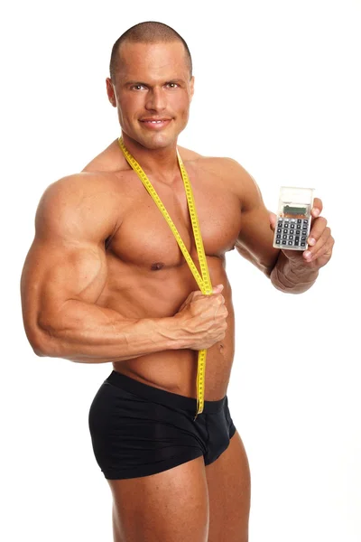 Uomo muscolare con contatore e calcolatrice — Foto Stock