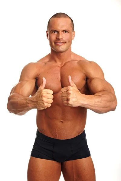 Muscular homem nu gesto polegares para cima sinal — Fotografia de Stock
