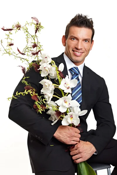 Homem com flores de Orquídeas — Fotografia de Stock