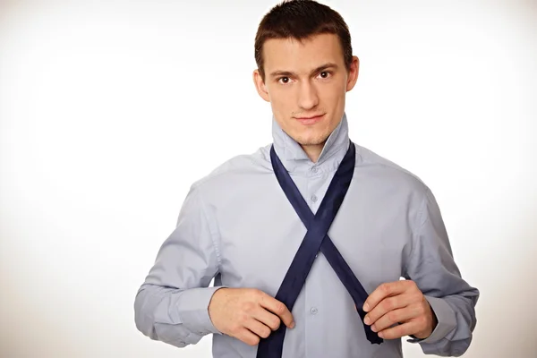 Businessman adjusts a tie — Stock Photo, Image