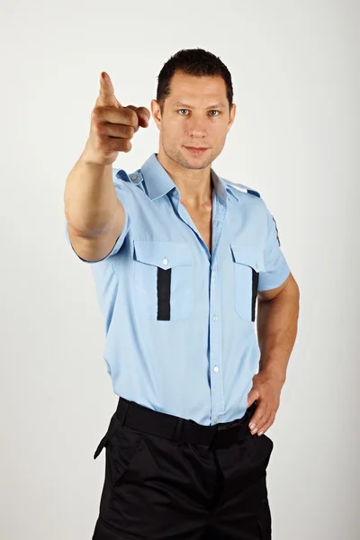 Policial apontando para a câmera — Fotografia de Stock