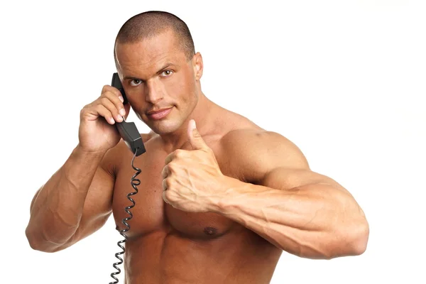 Handsome man talks into phone — Stock Photo, Image