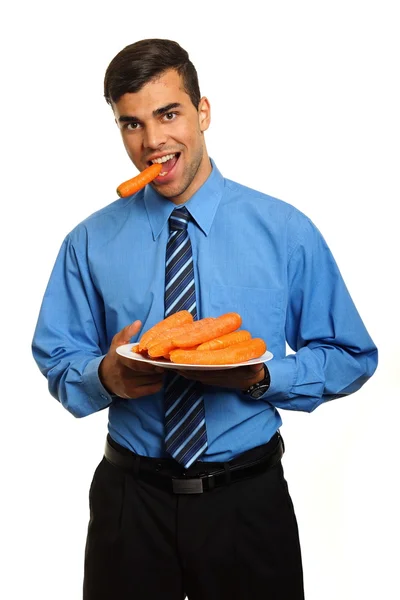 Homem surpresa com cenouras no prato — Fotografia de Stock