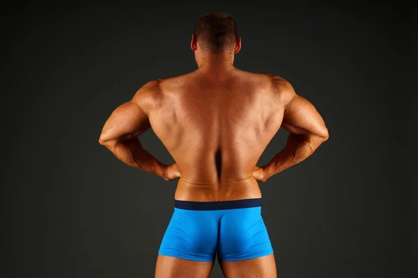 Big man shows his muscular back — Stock Photo, Image