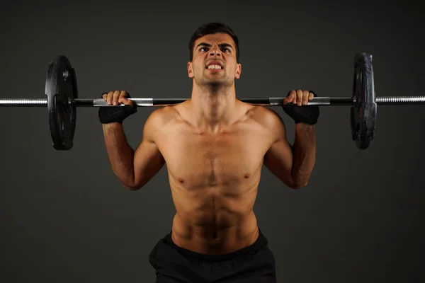 Athlete man exercises with dumbbell — Stock Photo, Image