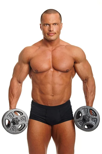 Muscular man exercises with dumbbell — Stock Photo, Image