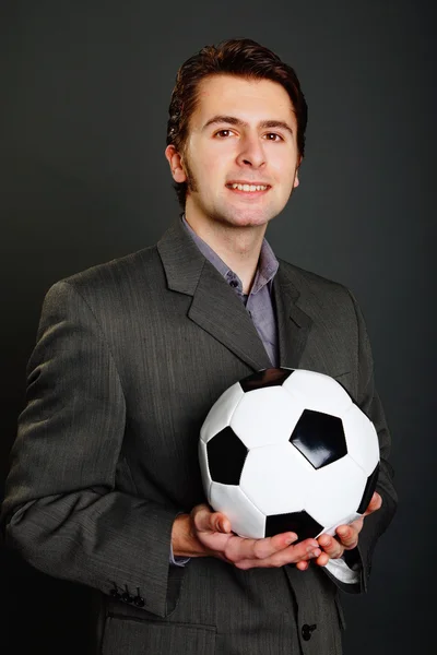 Businessman holds a soccer ball — Stock Photo, Image