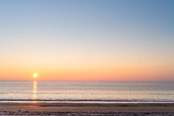 Panorama of Re island beaches with lighthouse in the horizon at sunrise with a very calm sea. seagull in the sky. beautiful minimalist seascape.