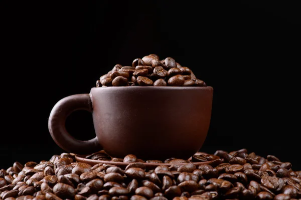 Cup with coffee beans — Stock Photo, Image