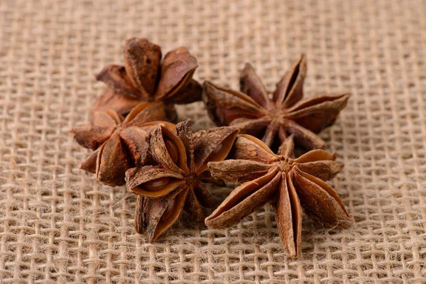 Star anise flowers on sacking — Stock Photo, Image