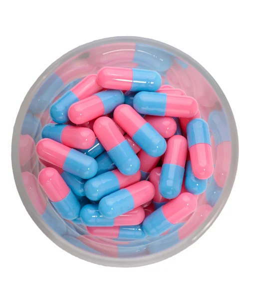 Tabletki, kapsułki w szkle — Zdjęcie stockowe