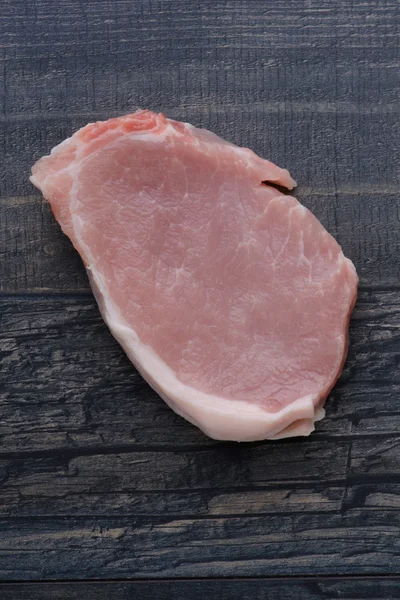 Raw meat steak on wooden board — Stock Photo, Image