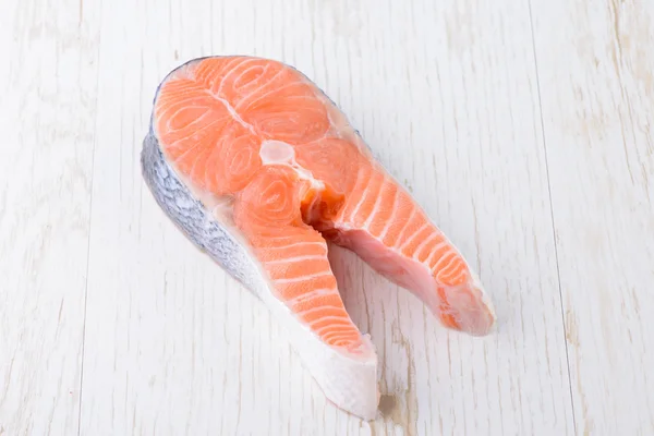 Raw salmon on a white board — Stock Photo, Image