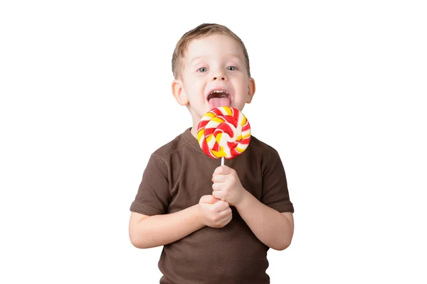 Kleiner Junge leckt einen Lutscher auf weißem Hintergrund — Stockfoto