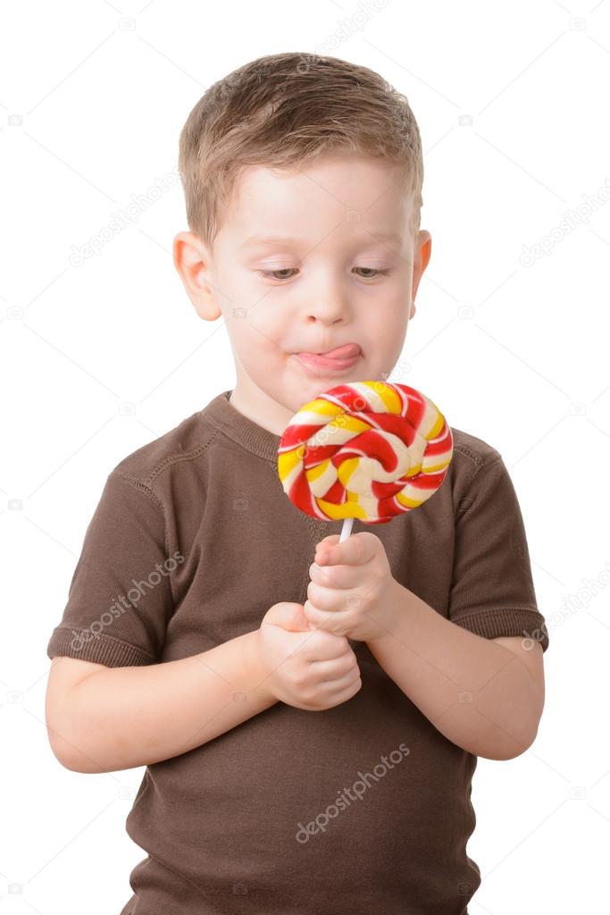 little boy licked with candy on a stick 