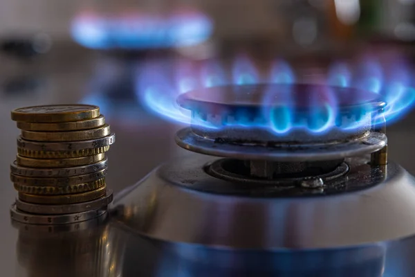 Gaz mutfak sobası, yanan ateş ve bozuk paralarla. Benzin masrafı.