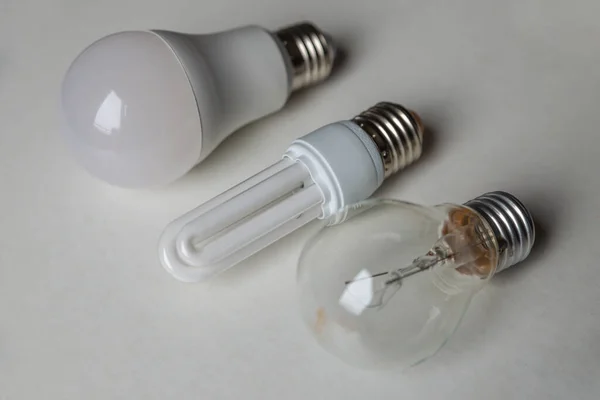 Incandescent bulb, fluorescent bulb, led bulb, next to each other. Technological evolution of light bulbs.