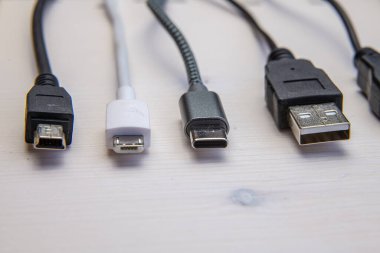 Ses, video, bilgisayar, akıllı telefon ve şarj bağlantıları için çeşitli kablolar ve kablolar. Analog ve USB konnektörlerinin türlerinin evrimi ve değişimi.