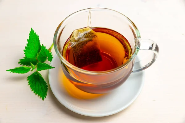 Nettle Herbal Tea Transparent Cup Sachet Immersed Water White Saucer — Stock Photo, Image