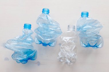 Crushed or crumpled clear plastic bottles. Plastic waste. Plastic recycling. Plastic pollution and waste management. 