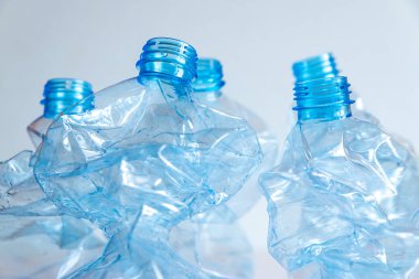 Crushed or crumpled clear plastic bottles. Plastic waste. Plastic recycling. Plastic pollution and waste management. 