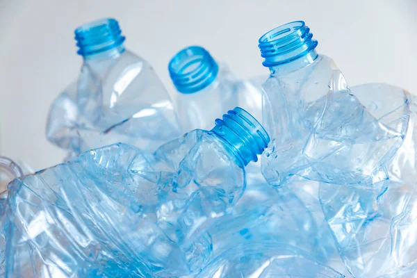 Crushed or crumpled clear plastic bottles. Plastic waste. Plastic recycling. Plastic pollution and waste management. 