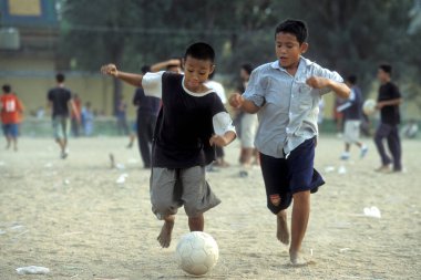 Çocuklar Kamboçya 'nın Phnom Penh şehrindeki Ulusal Müze önünde futbol oynarlar. Kamboçya, Phnom Penh, Şubat 2001