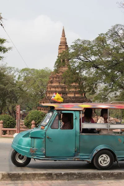 People on little car at ancient temple — Stockfoto