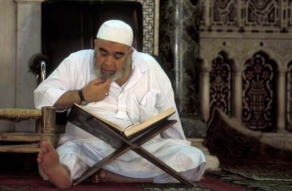 man reading Koran in Umayyad Mosque