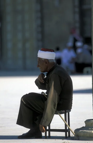 Senior man sitting near Umayyad Mosque Stock Picture