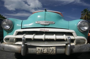 old american car in the town of Juangriego clipart