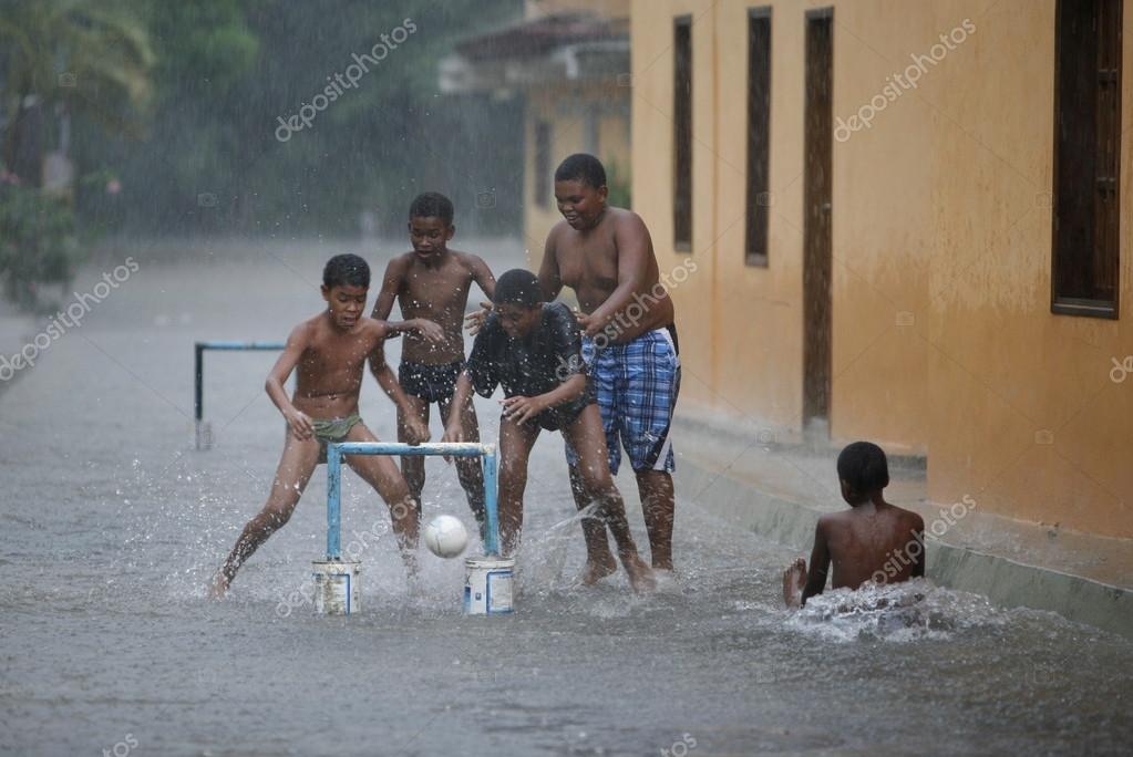 Children play soccer in rain Stock Editorial Photo © urf 94298174