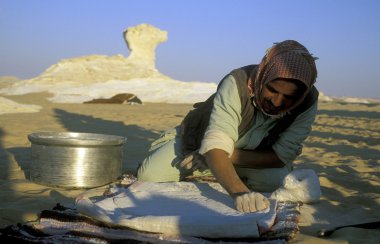 people bake fresh Bread in the white desert 