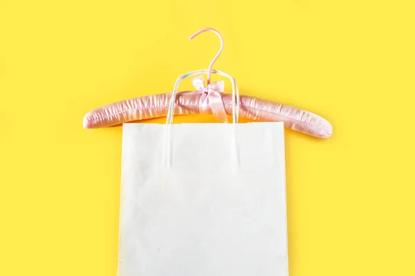 Порожній Рожевий Вішак Одягу Білий Паперовий Мішок Жовтому Тлі Копіювальним — стокове фото