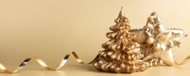 Noel ağacı şeklinde güzel altın bir mum ve pastel arka planda bir fotokopi alanı olan yıldız şeklinin Noel süslemesi. Noel ve Yeni Yıl konsepti. Asgari düzeyde. Pankart.