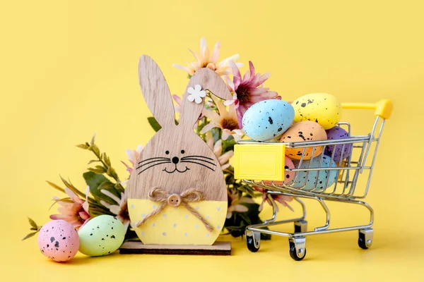 Easter Composition Colorful Eggs Shopping Cart Wooden Bunny Spring Flowers — Stock Photo, Image