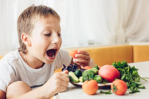 Boy Sitting Kitchen Eating Healthy Vegetables Cucumber Tomato — Stock Photo, Image