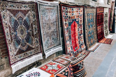 Antalya, Turkey - July, 2021: Carpet shop selling oriental colourful rugs on in street old town Kaleici district in Antalya, Turkey. Turkish bazaar clipart