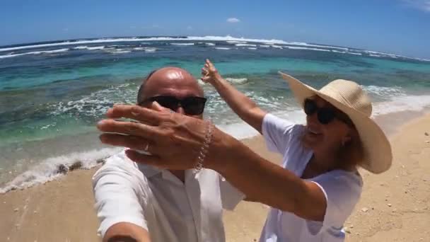 Romantic middle aged couple kisses and hugs on the beach. Anniversary trip — Stockvideo