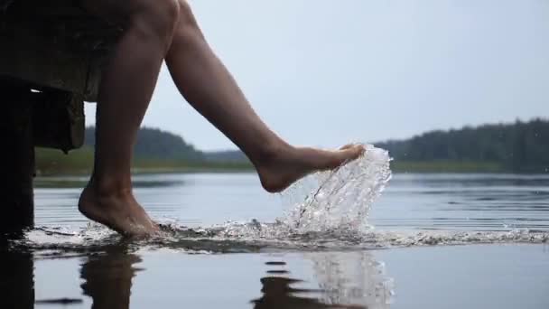 Kobieta nogi żartobliwie pluskając wodą jeziora ciesząc się jej czas. Święta nad jeziorem. Koncepcja samoopieki. — Wideo stockowe