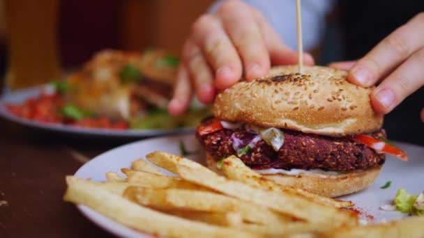 Comer hambúrguer Vegan saudável com batatas fritas. Fechar.. — Vídeo de Stock