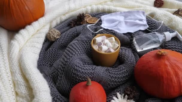 Second wave of Covid-19 pandemic survival kit : pumpkin, face mask, antiseptic and hot chocolate with marshmallows — Stock Video