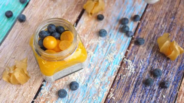 Chia Seed Vegan Pudding With Mango, Physalis And Blueberry. — Stock video