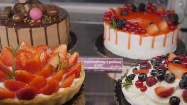 Primer plano de tartas de chocolate recién horneadas con crema en exhibición en la pastelería. Concepto de postres y dulces. — Vídeos de Stock