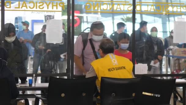 Boarding procedure according new safety requirements. People showing covid-19 test results to health care workers. Bali-June-2021 — Stock Video