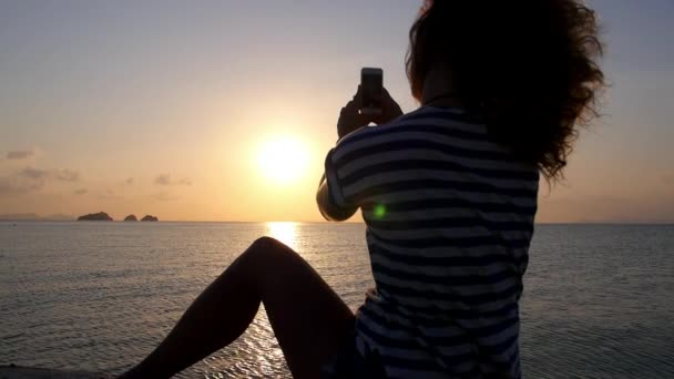 Žena, fotografování s Smartphone při západu slunce. Zpomalený pohyb. — Stock video